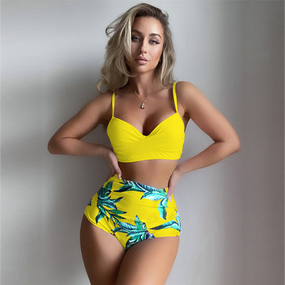 Woman wearing a bright yellow push-up bikini top and high-waisted bottoms with a green tropical leaf print. - Image 6