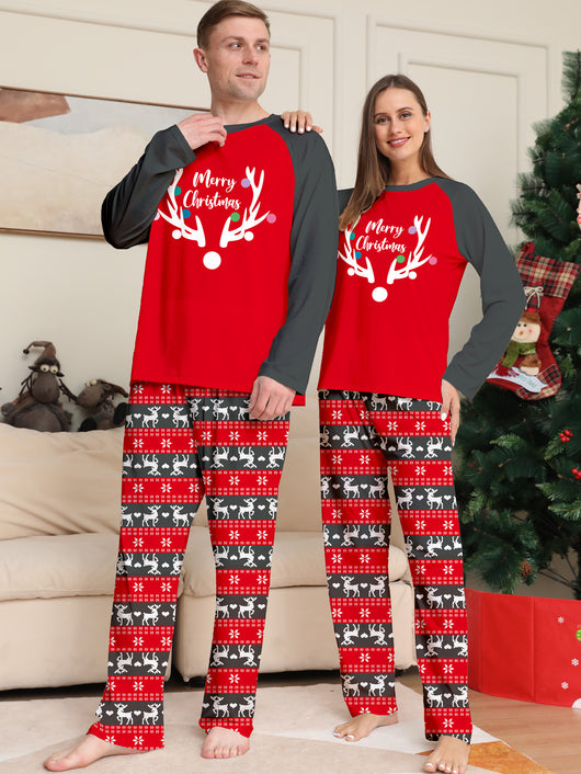 Family of four wearing matching red and black Christmas pajamas with a deer head and "Merry Christmas" print. - Image 3