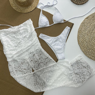 Woman wearing a white lace two-piece swimsuit set with a halter bikini top and sheer high-waisted flare pants. - Image 11