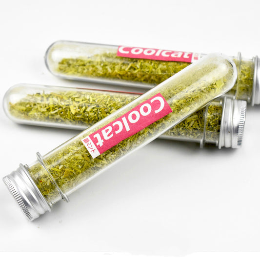 Three clear glass test tubes filled with green catnip, each with a pink 'Coolcat' label and silver screw caps.