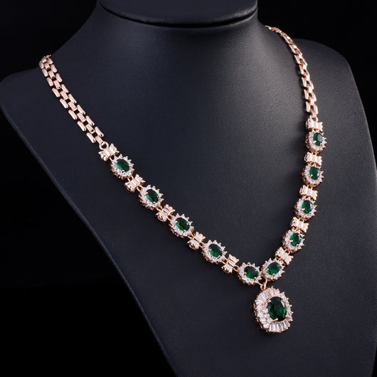 Rose gold tone jewelry set with oval blue gemstones and clear accents, including a necklace, bracelet, earrings, and ring. - Image 6