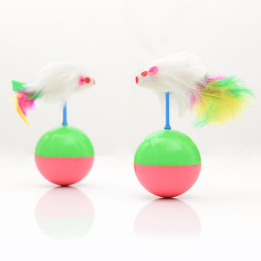 Two white mouse cat toys with colorful feathers on green and pink tumbler bases, reflected on a white surface.