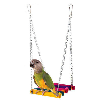 Colorful suspension bridge swing for birds, featuring wooden logs in green, purple, yellow, blue, and red, with small beads and metal chains.