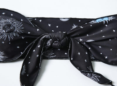 Black celestial print bikini set with a bandeau tie-front top and high-cut bottoms, featuring sun, moon, and star patterns. - Image 12