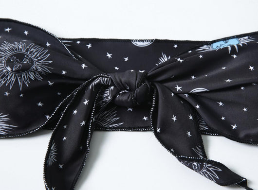 Black celestial print bikini set with a bandeau tie-front top and high-cut bottoms, featuring sun, moon, and star patterns. - Image 12