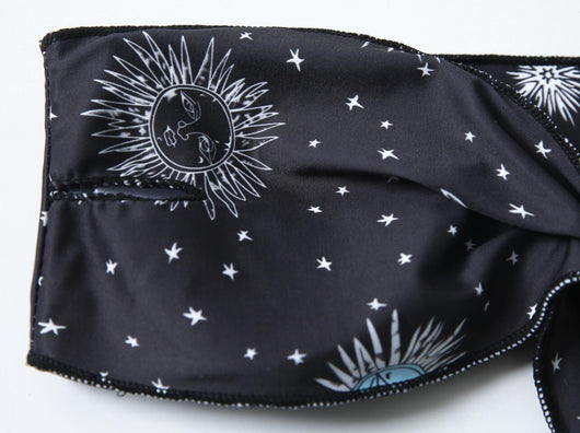 Black celestial print bikini set with a bandeau tie-front top and high-cut bottoms, featuring sun, moon, and star patterns. - Image 10