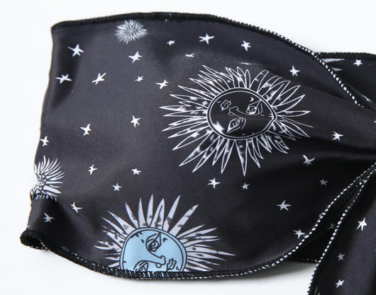 Black celestial print bikini set with a bandeau tie-front top and high-cut bottoms, featuring sun, moon, and star patterns. - Image 18
