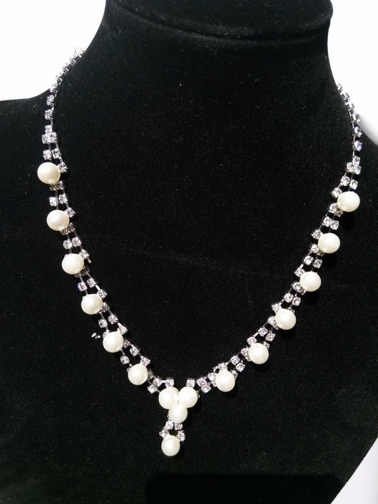 Silver-tone bridal jewelry set with a pearl and rhinestone necklace and matching dangle earrings. - Image 3