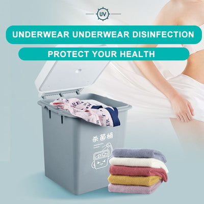 Gray UV sterilization box with an open lid, containing underwear, next to a stack of colorful folded garments.