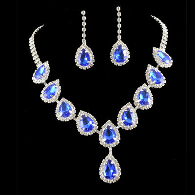 Bridal jewelry set with a silver-tone necklace and matching drop earrings, featuring orange teardrop rhinestones.