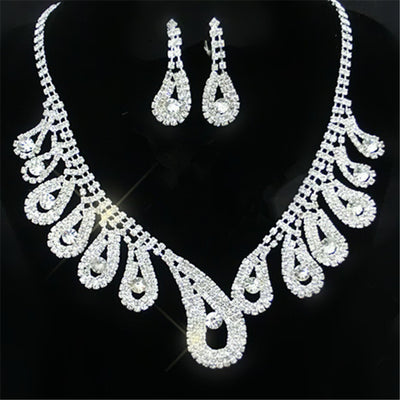 Silver-toned rhinestone necklace and matching drop earrings set with iridescent accents, ideal for bridal or formal wear. - Image 2