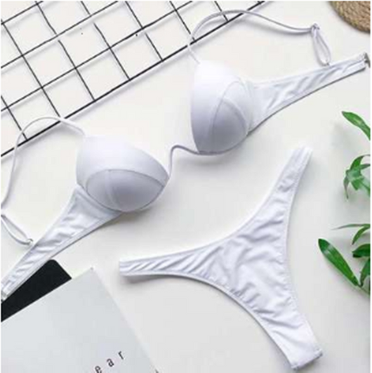 White two-piece bikini set with a push-up top and thong bottom, made of polyester, laid flat on a white surface. - Image 13