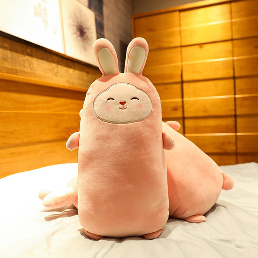 Pink rabbit plush doll with closed eyes, soft and elongated, standing on a bed. - Image 8