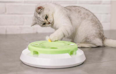 Round electric cat toy with a white base and a lime green top, featuring a rotating white feather. - Image 2