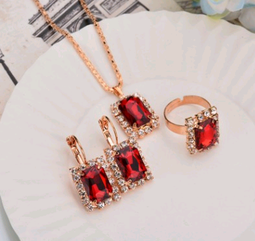 Rose gold-toned necklace, earrings, and ring set with large oval clear gemstones surrounded by smaller stones. - Image 28