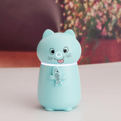White cartoon cat humidifier with a pink tongue, black eyes, and whiskers, holding a fish skeleton, with a glowing blue light band. - Image 8