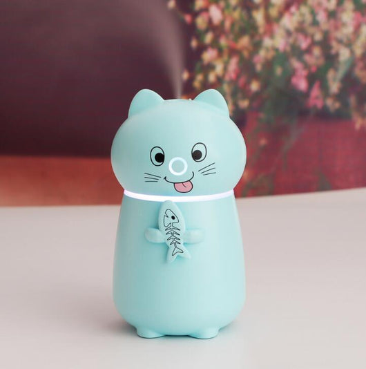 White cartoon cat humidifier with a pink tongue, black eyes, and whiskers, holding a fish skeleton, with a glowing blue light band. - Image 8