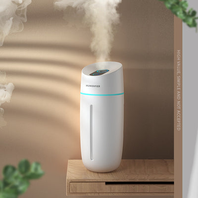 White desktop humidifier with blue LED light strip and control buttons, emitting mist on a wooden surface. - Image 7