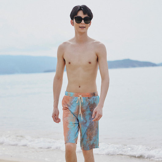 Men's or unisex swim shorts with a blue, orange, and brown abstract tie-dye print, featuring a drawstring waist and side pockets. - Image 12