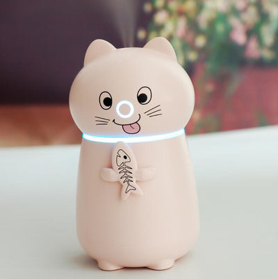 White cartoon cat humidifier with a pink tongue, black eyes, and whiskers, holding a fish skeleton, with a glowing blue light band. - Image 9