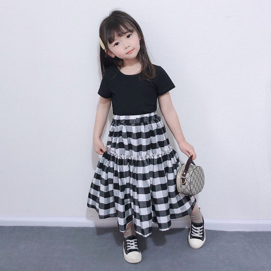 Matching black and white gingham two-piece outfits, one adult and one child size, with black short-sleeve tops and tiered skirts. - Image 2