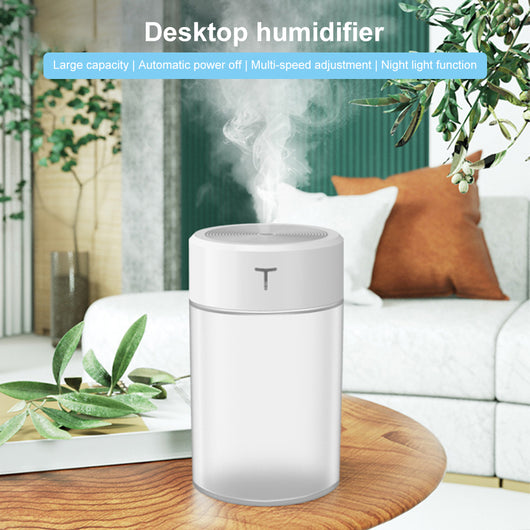 White and clear cylindrical mini humidifier with a 'T' logo, featuring a top mist outlet and transparent water tank.