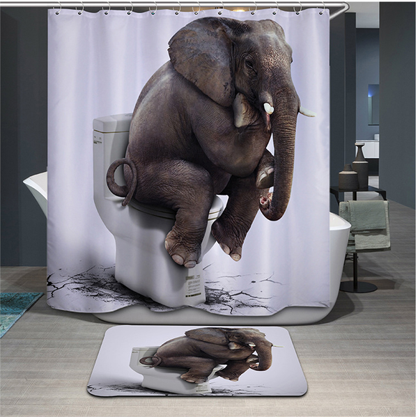 Funny elephant on toilet shower curtain and matching bath mat set in a modern bathroom.