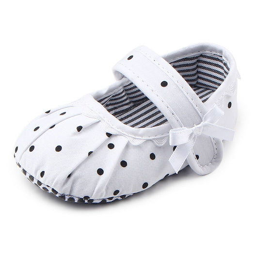 Black baby girl Mary Jane shoes with white polka dots, a strap, bow accent, and striped lining. - Image 5