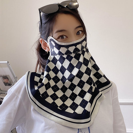 Female cream and black floral polka dot sun protection mask with ear loops, designed for eye corner protection. - Image 4