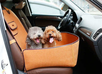 Light grey pet car seat with brown trim on a car's front passenger seat, holding two small dogs. Includes a black pet seatbelt tether. - Image 16