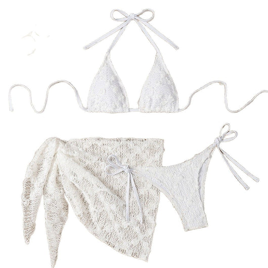 White lace halter bikini set with a matching mesh sarong, laid out on sand with sunglasses and a palm leaf. - Image 5