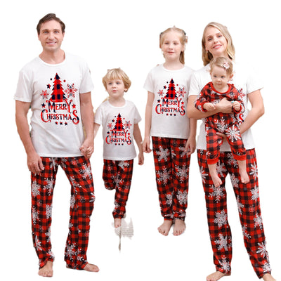 Family of five wearing matching Christmas pajamas with white 'Cousin Crew' tops and red plaid snowflake pants. - Image 7