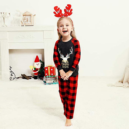Woman wearing a Christmas pajama set with a dark gray 'Merry Christmas MOMMY' reindeer top and red and black plaid pants. - Image 5