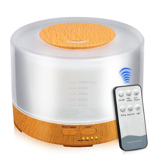 A cylindrical aromatherapy diffuser with a dark wood grain base and a translucent top glowing aqua blue, featuring control buttons. - Image 10