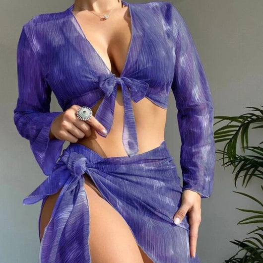 Purple and white striped four-piece women's swimsuit set with long-sleeve tie-front top, halter bikini, and sarong.
