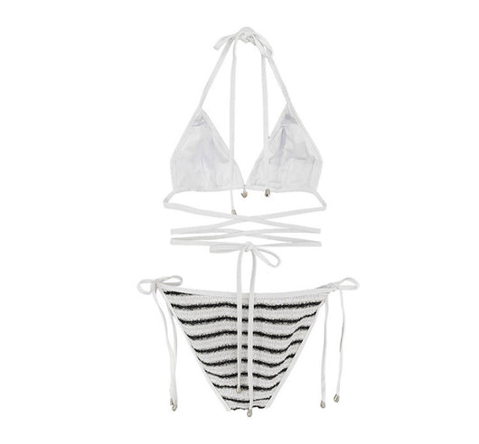 White and black striped bikini with triangle-cut top and tie-side bottom, modeled outdoors. - Image 34