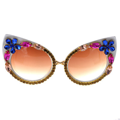 White cat-eye sunglasses with brown gradient lenses, adorned with clear and amber rhinestone flowers and bees. - Image 6