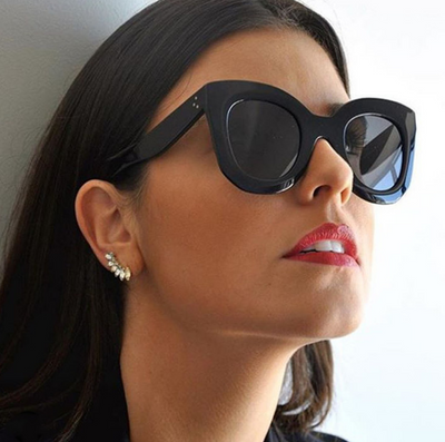 Transparent pink cat-eye sunglasses with gradient gray lenses, featuring a thick frame and vintage style. - Image 3