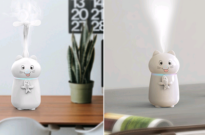 White cartoon cat humidifier with a pink tongue, black eyes, and whiskers, holding a fish skeleton, with a glowing blue light band. - Image 4