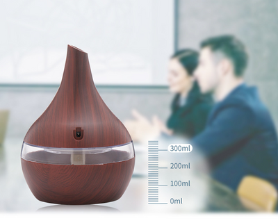 Teardrop-shaped humidifier with light wood grain finish and clear water tank, featuring a power button icon. - Image 6