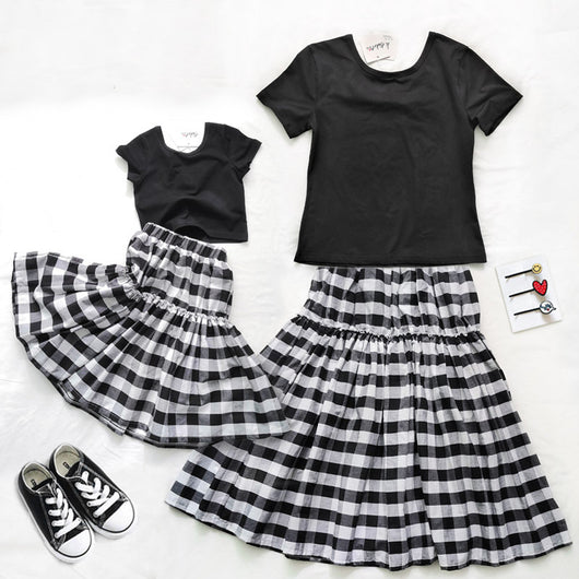 Matching black and white gingham two-piece outfits, one adult and one child size, with black short-sleeve tops and tiered skirts. - Image 6