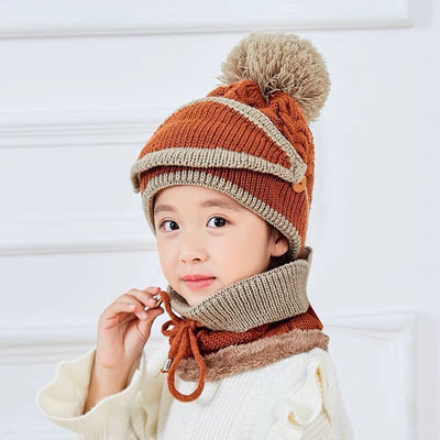 Young child wearing a pink and grey knitted hat with a pom-pom and a matching neck warmer with a drawstring. - Image 14