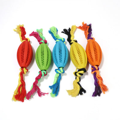 Green rubber pet molar toy with a football shape and textured surface, featuring red and green braided rope knots.