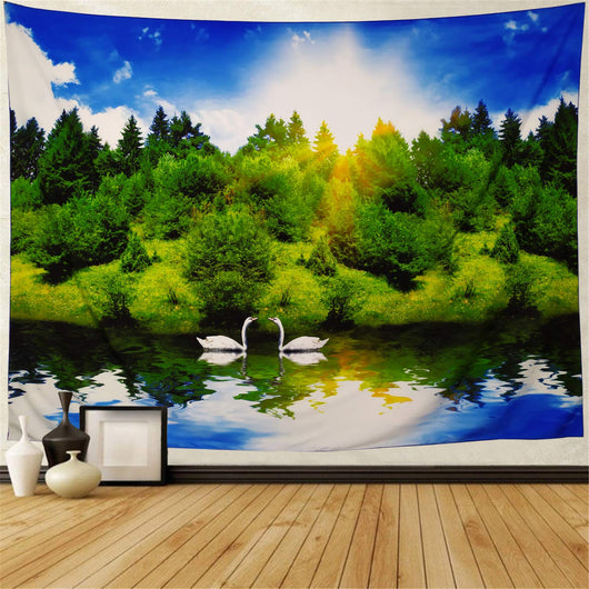 Printed tapestry featuring a vibrant forest and lake scene with two white swans under a bright blue sky with sun rays.