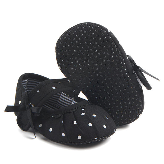 Black baby girl Mary Jane shoes with white polka dots, a strap, bow accent, and striped lining. - Image 6
