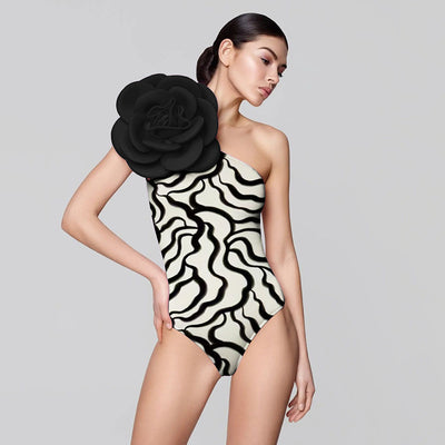 Black one-piece swimsuit with a large 3D flower on one shoulder and a geometric pattern on the bodice. - Image 20