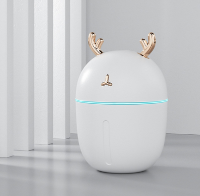 Pink deer-shaped mini humidifier with gold antlers and a glowing blue light band, on a pink background. - Image 12