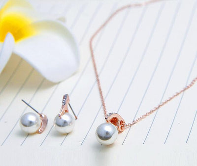 Rose gold-toned necklace and earring set with white pearls and clear rhinestones, ideal for bridal or formal wear. - Image 5