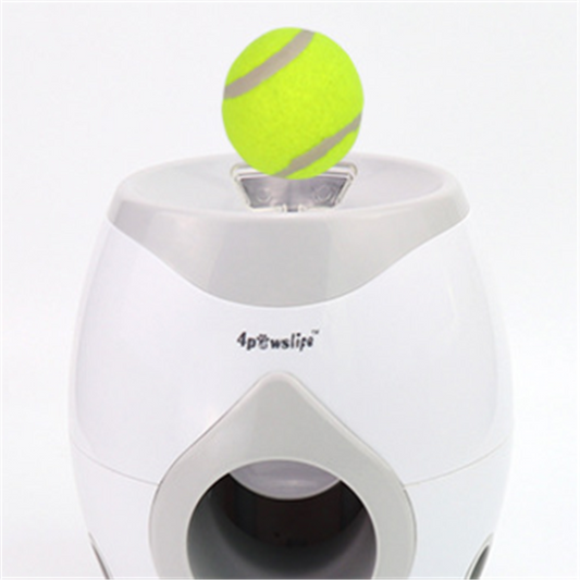 White and grey automatic tennis ball launcher for dogs, dispensing food, with a tennis ball and kibble bowl. - Image 2