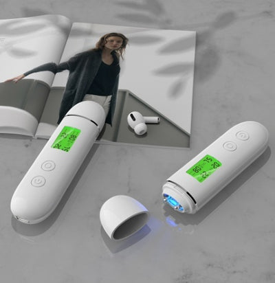 White rechargeable smart facial skin tester with green digital display, USB-C charging cable, and user manual.